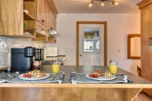 a kitchen with two plates of food on a counter at Spacious cottage in forest with spa in La Macaza