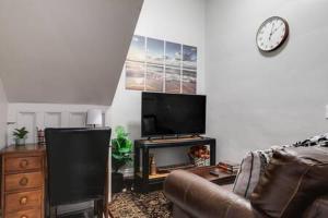uma sala de estar com um sofá, uma televisão e uma lareira em G2 CENTRAL LOCATION museums FREE PARKING em Richmond