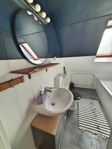 a bathroom with a sink and a toilet at Über den Dächern von Witten bis 6P in Witten