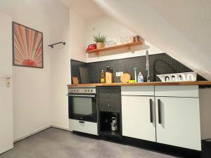 a kitchen with a black and white stove top oven at Über den Dächern von Witten bis 6P in Witten
