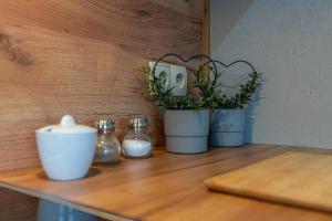 three potted plants sitting on a wooden table at Domki na Wiyrchu in Biały Dunajec