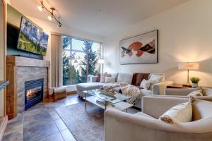 a living room with a couch and a fireplace at Central 2BR with Prime Amenities in Whistler