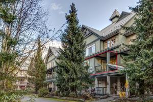 a house with a tree in front of it at Central 2BR with Prime Amenities in Whistler