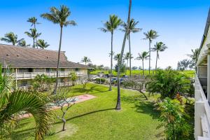 an exterior view of a resort with palm trees at Plantation Hale G14 in Kapaa