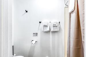 a bathroom with white towels hanging on a shower curtain at Mount Worthington Room 6 at Mount Walker Inn in Quilcene