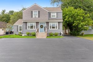 a house with a blue door and a driveway at Jerry's Way in Lake George