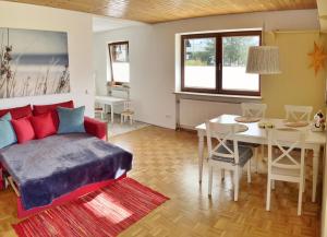 a living room with a couch and a table at Open Garden Mountain Lodge in Oberaudorf