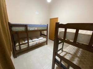 a room with two bunk beds and a staircase at Casa Por do Sol in Águas de Santa Barbara