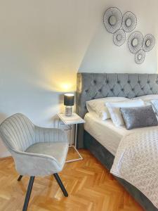 a bedroom with a bed and a chair in it at Apartment Dario in Zadar