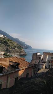 a group of buildings with the ocean in the background at Mela & Cannella accommodation in Minori