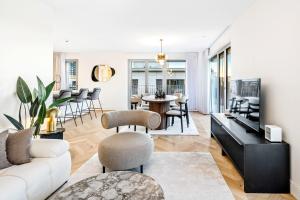 a living room with a white couch and a table at Stylish 3BR Apt - Heart of Luxembourg - Jacuzzi in Luxembourg