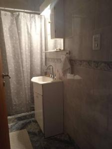 a bathroom with a sink and a shower at Departamento equipado Río Grande in Río Grande