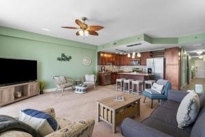 een woonkamer met een bank en een tv bij Nautical Nest at Laketown Wharf #1019 by Nautical Properties in Panama City Beach