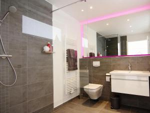 a bathroom with a shower and a toilet and a sink at Ferienhaus am Yachthafen in Peenemuende in Peenemünde +29 photos