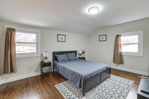 a white bedroom with a bed and two windows at 2-Story Lawnside Home 13 Mi to Dtwn Philadelphia! 
