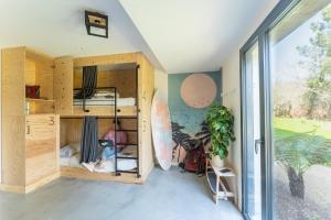a room with bunk beds and a large window at HEJMO in Hossegor
