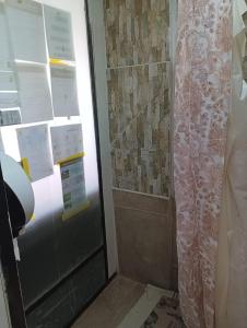 a shower in a bathroom with a shower curtain at Hostal Pampaloja in Antofagasta