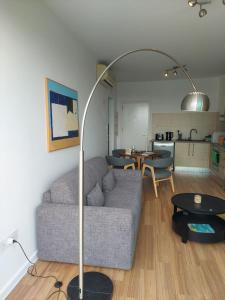 a living room with a couch and a floor lamp at Milepost vacations in Paralimni