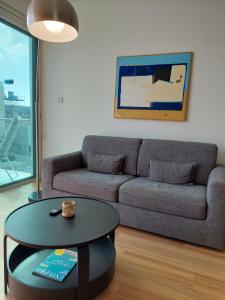 a living room with a couch and a table at Milepost vacations in Paralimni