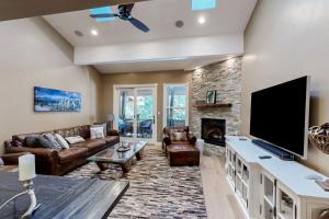 a living room with a large television and a fireplace at High Sierra Haven in Incline Village
