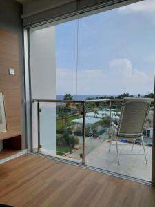 a chair on a balcony with a view of the ocean at Milepost vacations in Paralimni