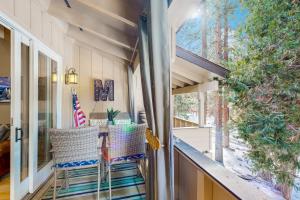 a screened in porch with two chairs and a table at High Sierra Haven in Incline Village