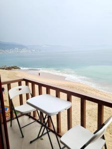 - 2 chaises et une table sur un balcon donnant sur la plage dans l'établissement Hotel los tules 12-501, à Puerto Vallarta