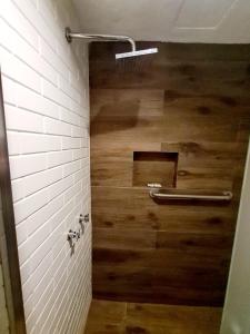 a bathroom with a shower with a wooden floor at Hotel los tules 12-501 in Puerto Vallarta