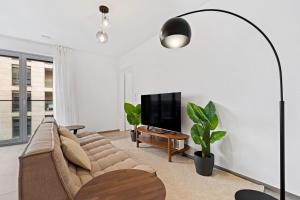 A television and/or entertainment centre at Luxurious 1-BR Apt in Gasperich, Luxembourg