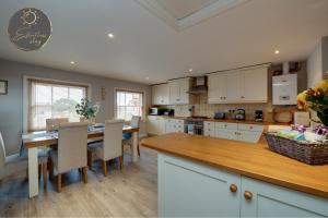 a kitchen with a table and chairs and a dining room at Leeward House -Solent views, Parking,High Street Location, Couples, Groups, Families and Professionals Welcome in Lymington