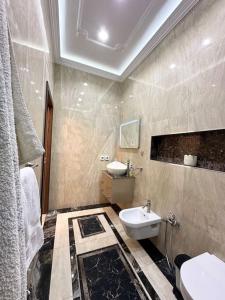 a bathroom with a sink and a toilet in it at Villa Artemis (Ground Floor) in Rejiche