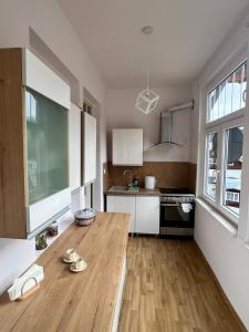 a kitchen with a wooden table in a room at Apartament Lucjanek in Karpacz