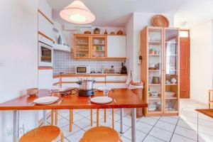 a kitchen with a wooden table with two chairs at Cabana & Le Paisible - Proche Lac in La Pirraz +11 photos