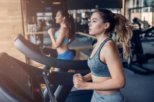 two women running on a treadmill in a gym at Lovely Caravan With Decking At Solent Breeze In Hampshire Ref 38195sb in Warsash