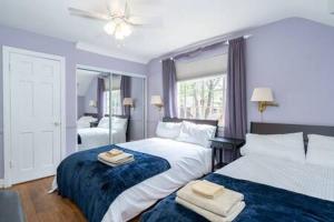 a bedroom with two beds with towels on them at Spacious 4BR CozySuites in Old Town Alexandria in Alexandria