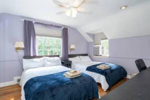 a bedroom with two beds and a window at Spacious 4BR CozySuites in Old Town Alexandria in Alexandria