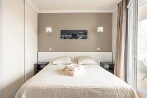 Katil atau katil-katil dalam bilik di Appartement lumineux au calme