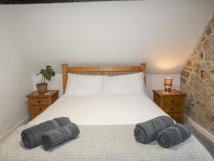 a bedroom with a large bed with two night stands at 5 The Crescent in Caernarfon
