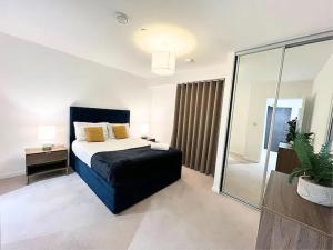 a bedroom with a bed and a large glass window at Large Morden 1 Bed Apartment London Catford Lewisham with great transport links in London