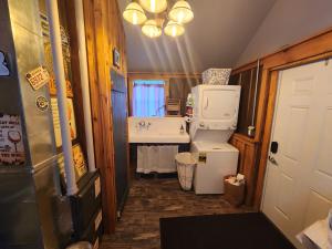 a small bathroom with a sink and a refrigerator at The Stable at Windmill Ridge Farm in Fredonia