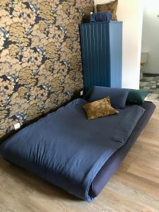 a blue bed with a pillow on top of it at Maison de campagne : « Après moi » / Baie de Somme in Lanchères
