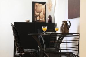 a black table and two chairs with drinks on it at Premium Class Apartments III in Zagreb