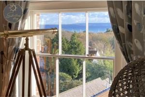 a large window with a view of the ocean at Leeward House - Luxury, Spacious, Sea View Apartment, Parking, Central Lymington in Lymington