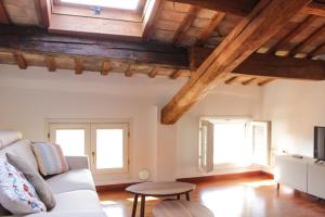 a living room with a couch and two windows at Sant'Agata in Ravenna