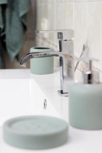 a bathroom sink with a faucet and two toilets at Sant'Agata in Ravenna +12 photos