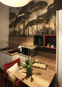 a kitchen with a counter with a table and a table sidx sidx sidx at Grottino 3a Apartment in Rome