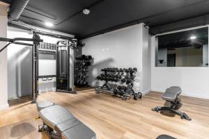 a gym with dumbbells and weights in a room at The Tokyo 710 in Cape Town