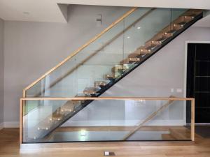 a glass staircase in a room with a stair case at Modern Catskill House & Lake NY with hot tube on the roof in Stamford