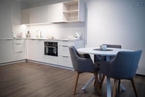 a kitchen with a table and chairs in a room at good mood guesthouse in Otepää