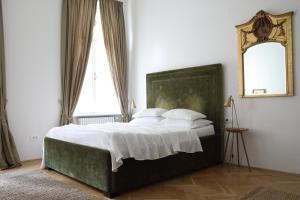 a bedroom with a large bed and a mirror at Premium Class Apartments III in Zagreb